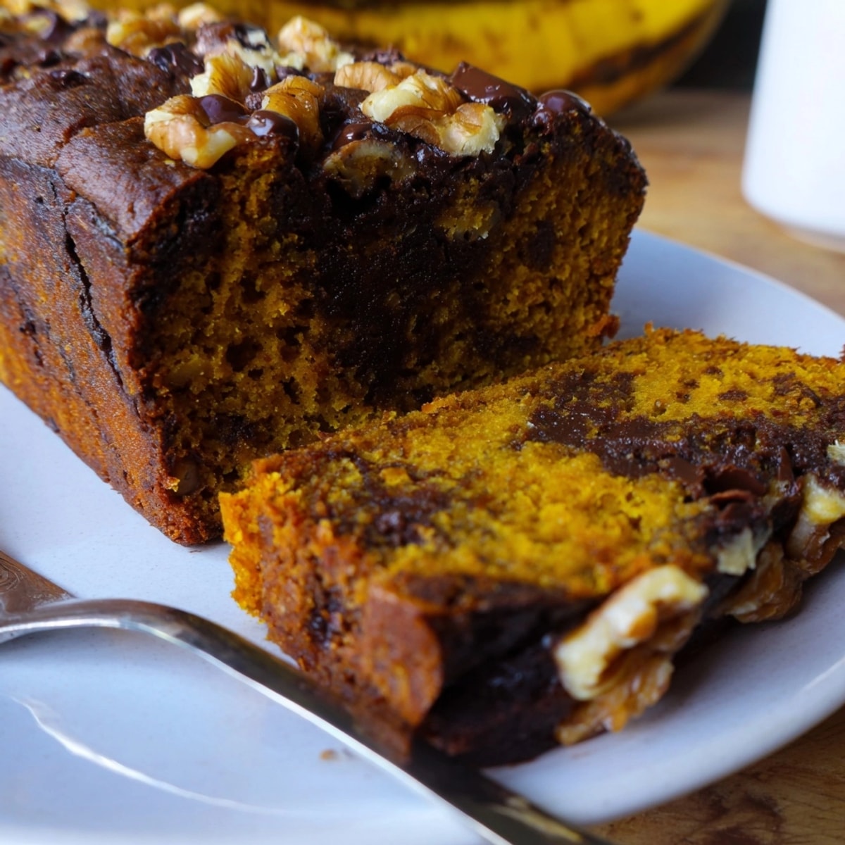 Freshly baked Protein Pumpkin Banana Loaf with cinnamon scent, ready to slice.