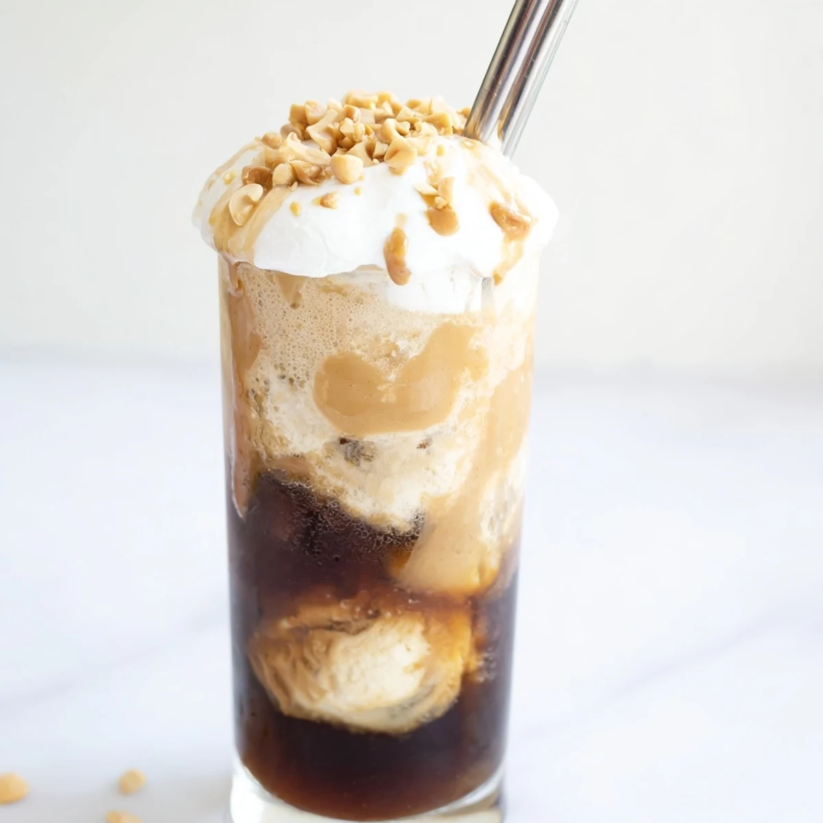 Decadent Peanut Butter Bourbon Soda Float featuring vanilla ice cream and roasted peanuts.