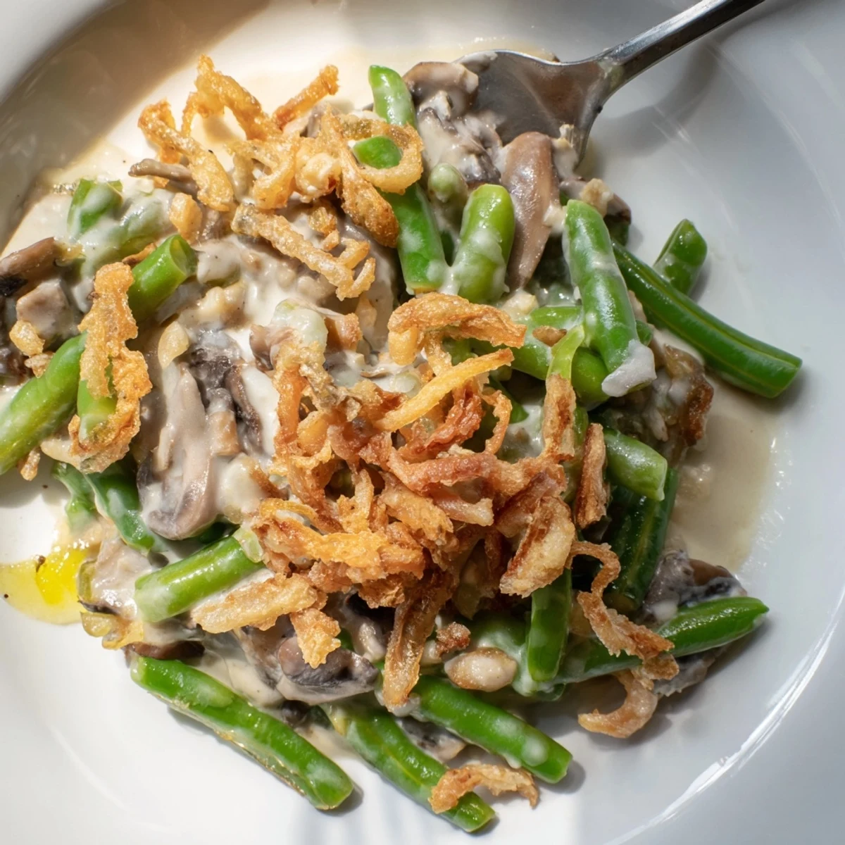 Creamy Old-School Green Bean Casserole topped with crispy fried onions, perfect for family gatherings.  