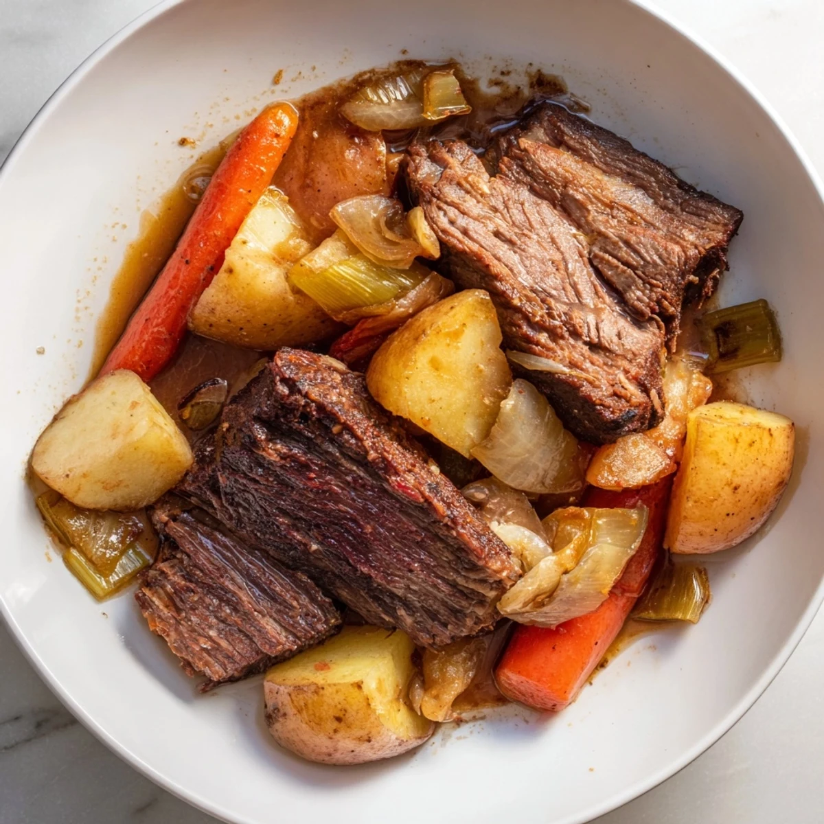 Steaming Sunday Pot Roast with roasted vegetables, fork-tender beef and a rich, savory gravy.