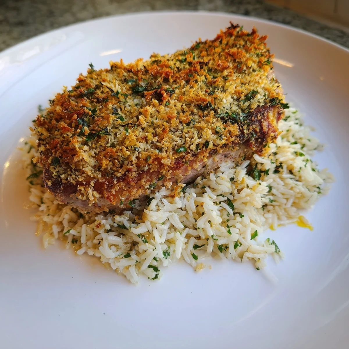 Golden-crusted Parmesan Herb Pork Chops served with fluffy rice, an easy, tempting weeknight dinner.