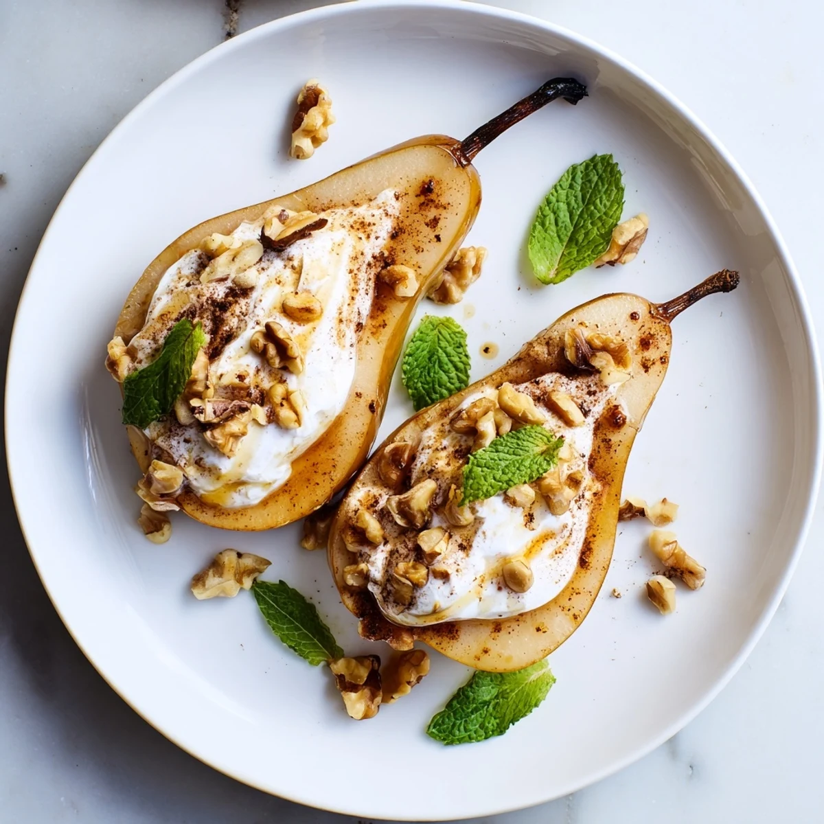 Warm, caramelized roasted pears with cinnamon, walnuts, and Greek yogurt make a delicious dessert.