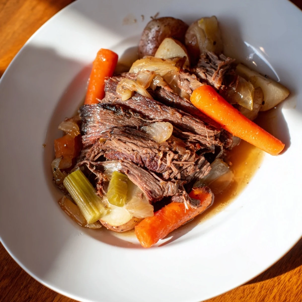 Fork-tender Pickle Brine Pot Roast with vegetables, swimming in a rich, savory gravy, ready to serve.