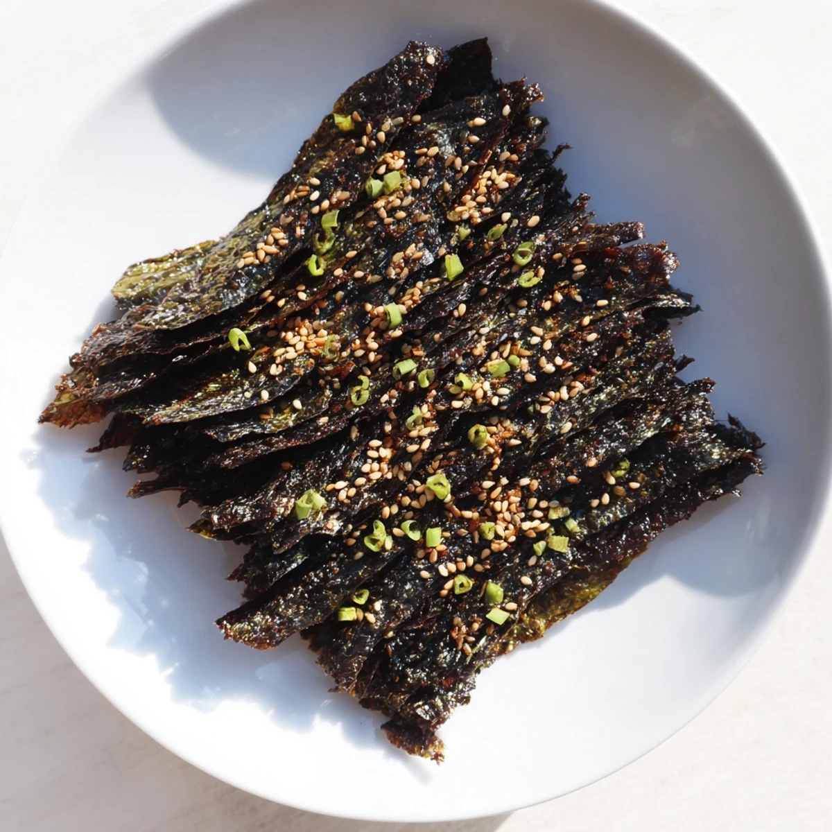 Stacked bite-sized Snacks de Vague Surf, sprinkled with sesame seeds for added flavor and texture.