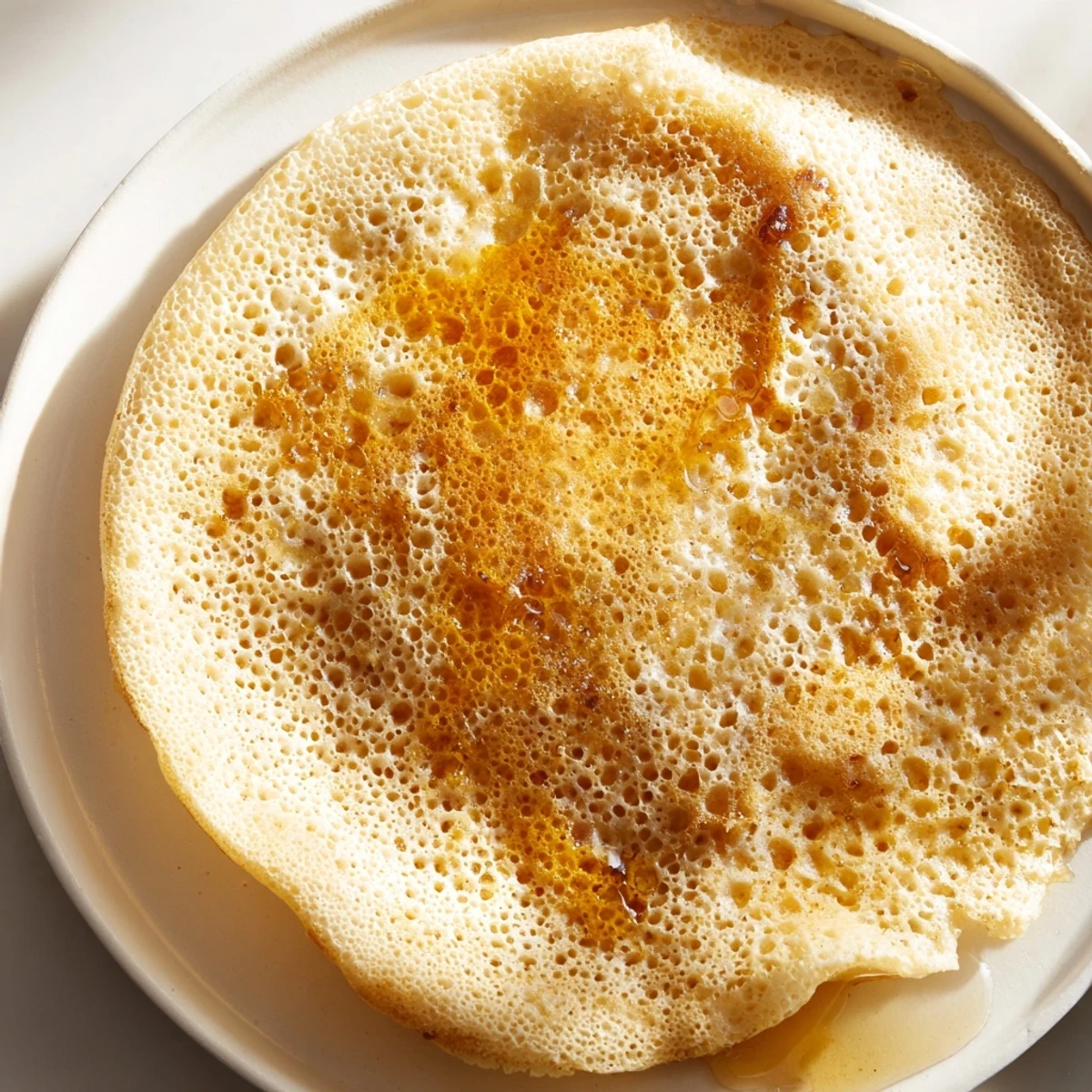 Homemade Moroccan Baghrir, the perfect North African pancake, offers a delightful spongy texture.