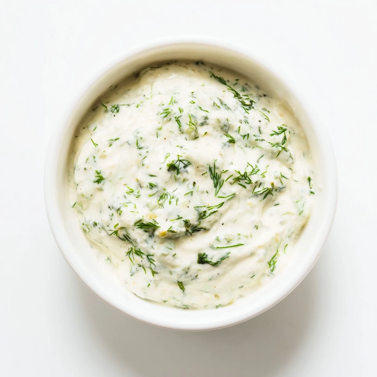 Creamy Greek yogurt herb dip, pictured with colorful, fresh herbs—a perfect appetizer.