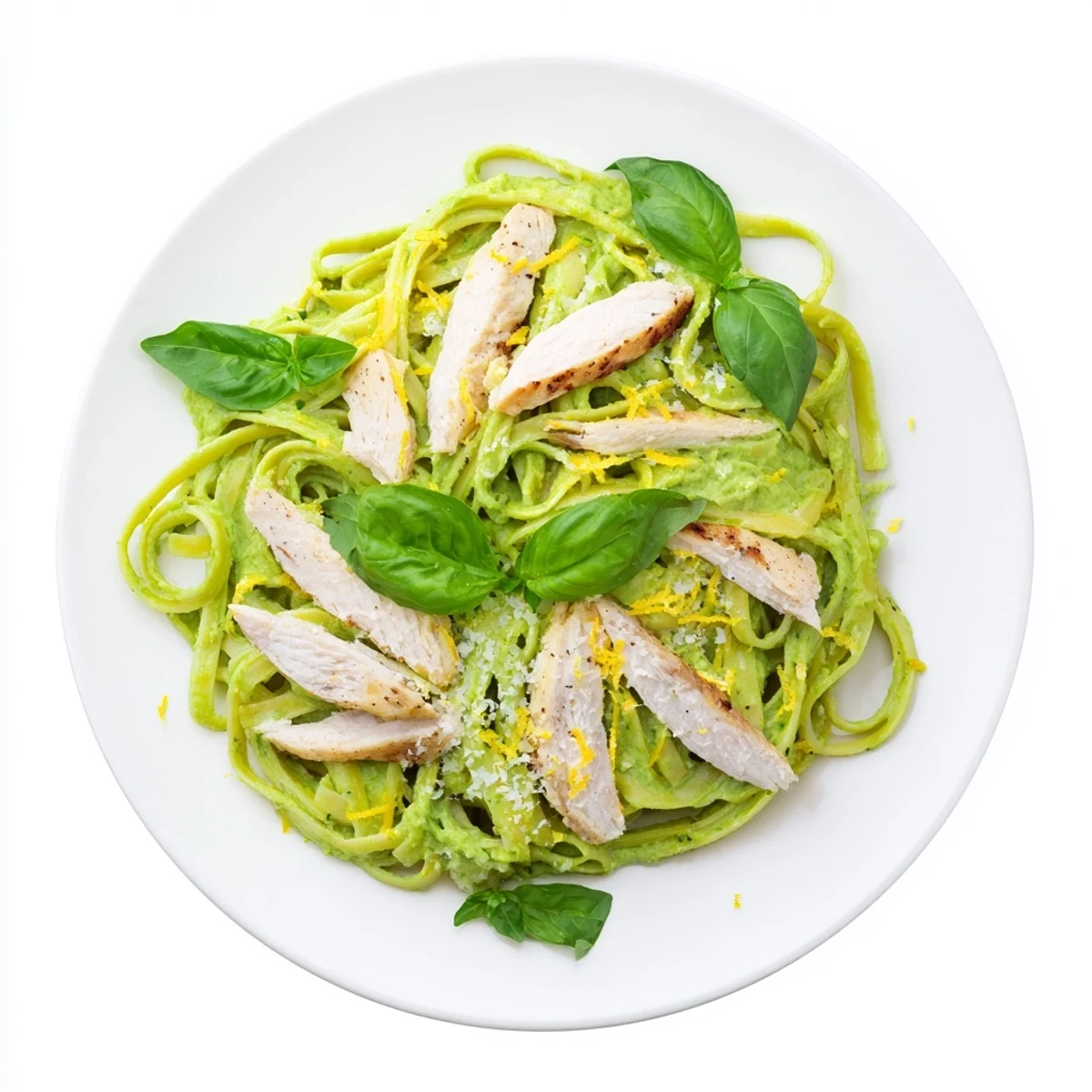 Creamy avocado chicken pasta in a white bowl shows bright green sauce coating every strand of spaghetti.