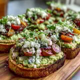 Spring Brunch Avocado Toast Board with Toppings: A colorful spread of creamy avocado toast topped with radishes, cherry tomatoes, and feta cheese, perfect for a leisurely weekend gathering.