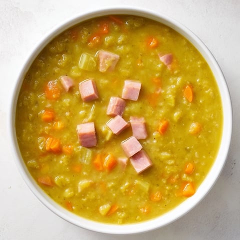 Steaming bowl of hearty Split Pea and Ham Soup, thick and flavorful, ready to be served hot.