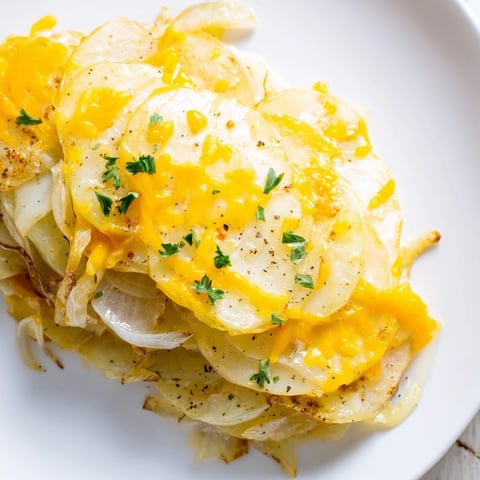 Golden, bubbly Budget-Friendly Potato Layer Bake with melted cheese and tender potato slices; a hearty meal.