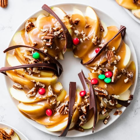 A festive Caramel Apple Slice Christmas Wreath, glistening with caramel and chocolate, perfect for holiday gatherings.