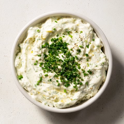 A vibrant veggie ranch dip, creamy and tangy, served with colorful fresh vegetable sticks.