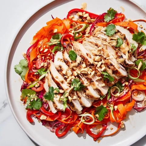 A colorful, enticing photo of Carrot Ribbon and Chicken Slaw, with tender chicken and crunchy vegetables.