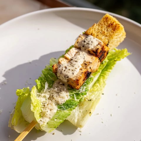 Grilled Chicken Caesar Salad Skewers: a beautiful display of chicken, lettuce, croutons, and Caesar dressing.