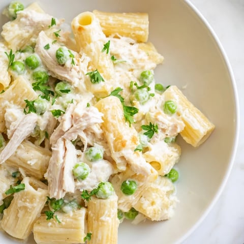 Tender, shredded chicken amidst creamy sauce and pasta in this slow cooker Chicken Alfredo dish.