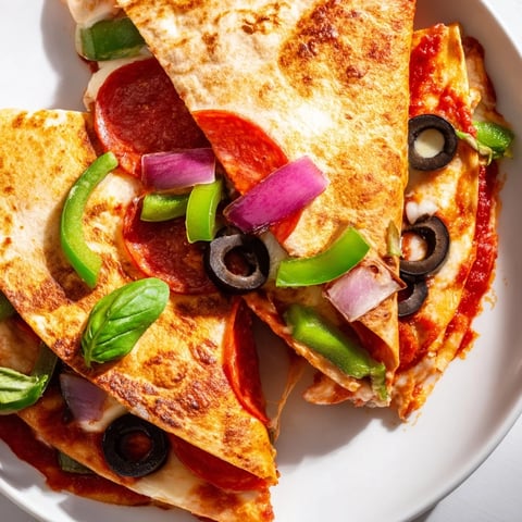 Tortilla pizza wrap, a handheld meal with melty cheese and folded tortilla edges, ready to eat.