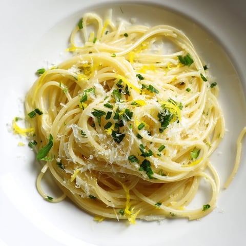 Golden, buttery Lemon Capellini with fresh herbs, a vibrant, light Italian pasta dish.