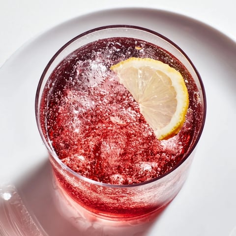 A chilled glass of the Sleepy Girl Mocktail, a refreshing cherry-infused bedtime beverage.