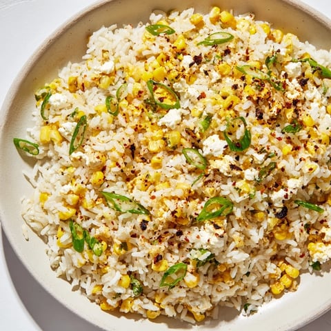 Fluffy Mexican Street Corn Rice, loaded with charred corn, cotija, and lime, ready to serve.