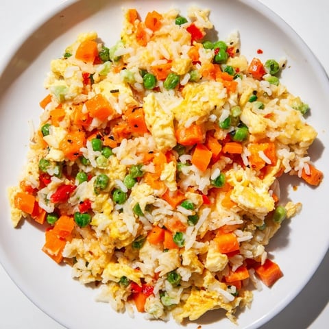Steaming bowl of Egg Fried Rice, a quick and delicious weeknight dinner with fluffy eggs.