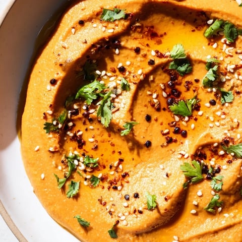 Creamy Carrot Ginger Dip, a vibrant appetizer ready to scoop up with fresh veggie sticks.