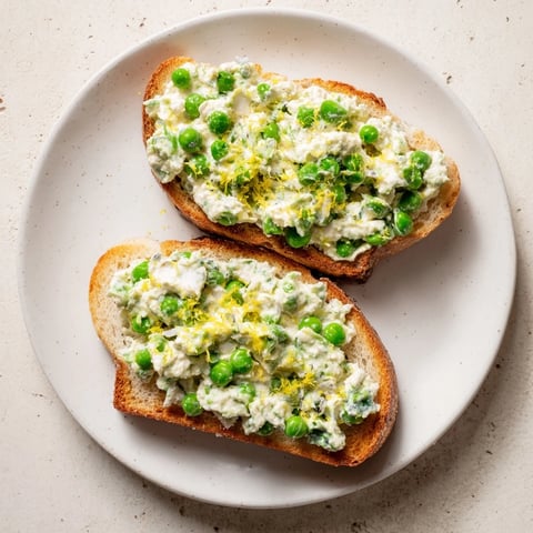 Crisp sourdough toast topped with creamy Pea & Mint Ricotta spread, finished with fresh lemon zest and a drizzle of olive oil.