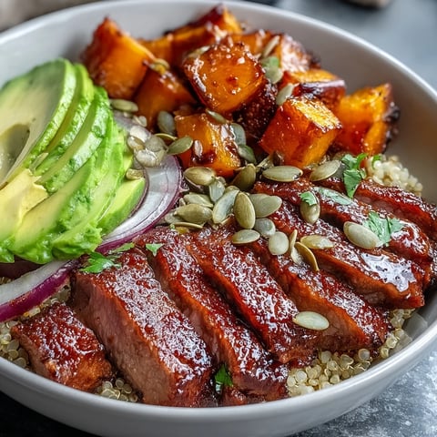 Golden roasted butternut squash steak bowls over fluffy quinoa, topped with creamy avocado and toasted pepitas.