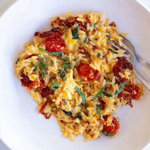 Warm, cheesy Sun-Dried Tomato Orzo Bake, ready to be served, a comforting Mediterranean-inspired meal.