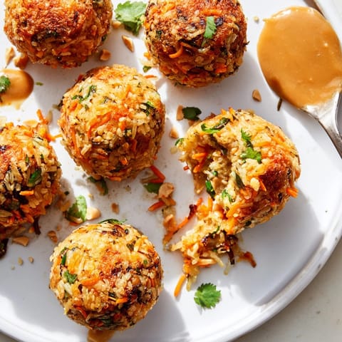 Imagine crispy Thai Peanut Fried Rice Balls: crunchy panko exterior, savory peanut aroma.