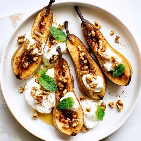 A plate of flavorful roasted pears with cinnamon, walnuts, and creamy Greek yogurt—perfect for a healthy treat.