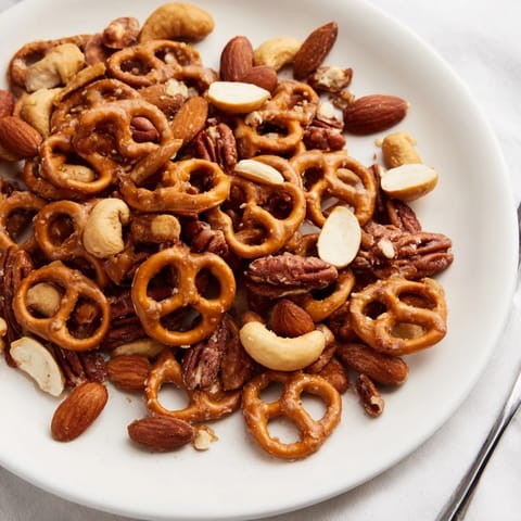 Golden, glistening salted caramel pretzels and nuts snack mix, perfect for sharing.