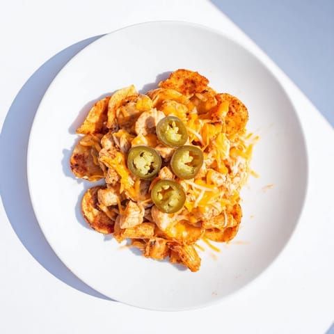 A close-up of delicious Pasta Chip Nachos, a creative twist on classic loaded nachos with fresh toppings.