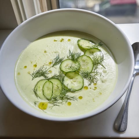 Chilled Cucumber Garlic Soup with a vibrant green hue, perfect for a refreshing vegetarian meal.