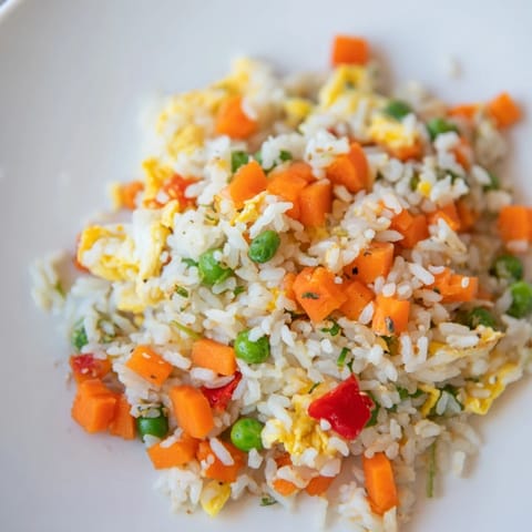 Golden-yellow Egg Fried Rice with colorful vegetables, perfect for a flavorful Asian-inspired meal.