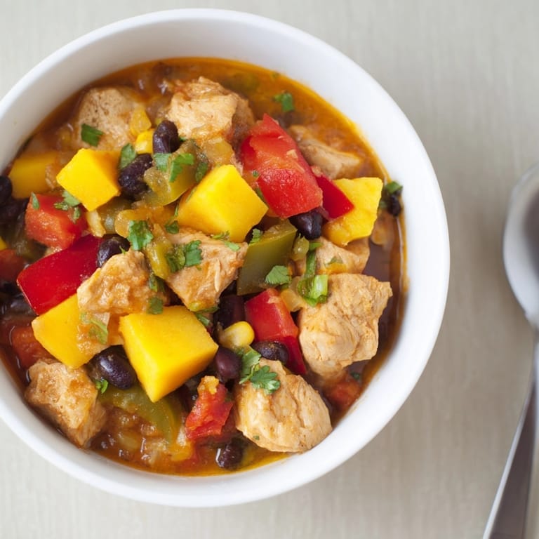 Delicious bowl of Mango Southwest Chicken Chili, steamy and topped with cilantro.