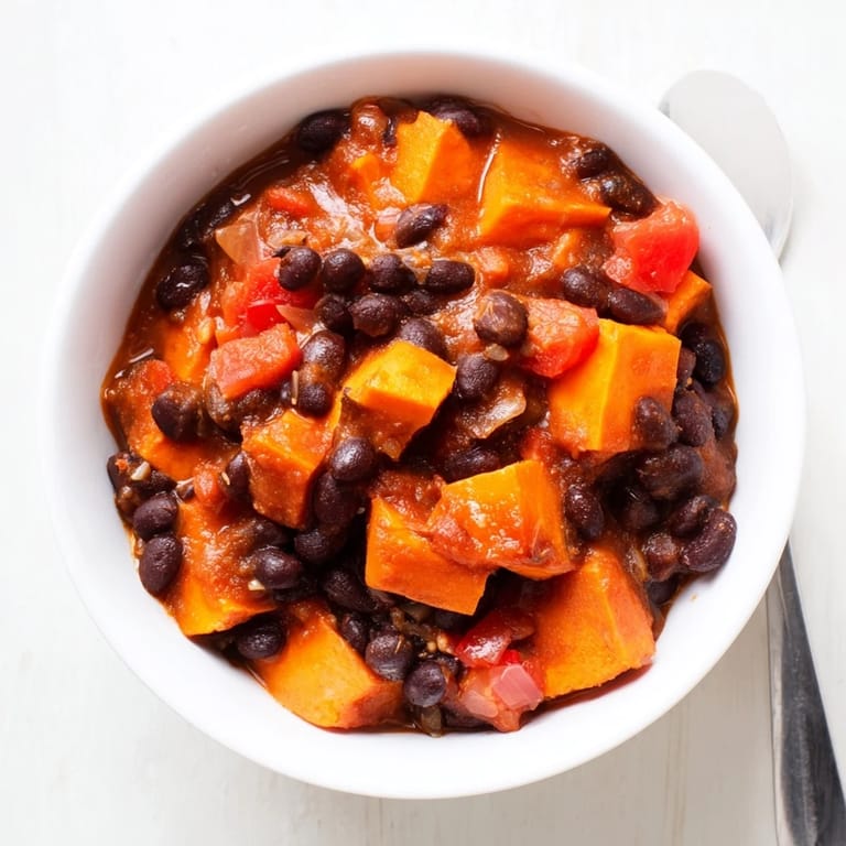 Colorful bowl of sweet potato and black bean chili, perfect with cornbread.  
