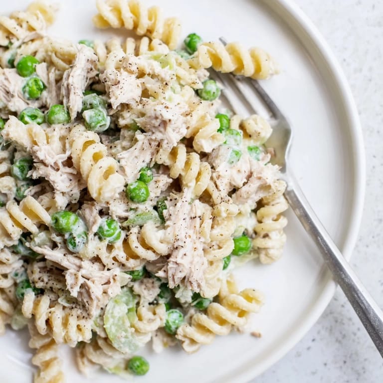 Hearty tuna pasta salad drizzled with light mayo, perfect for quick meals.