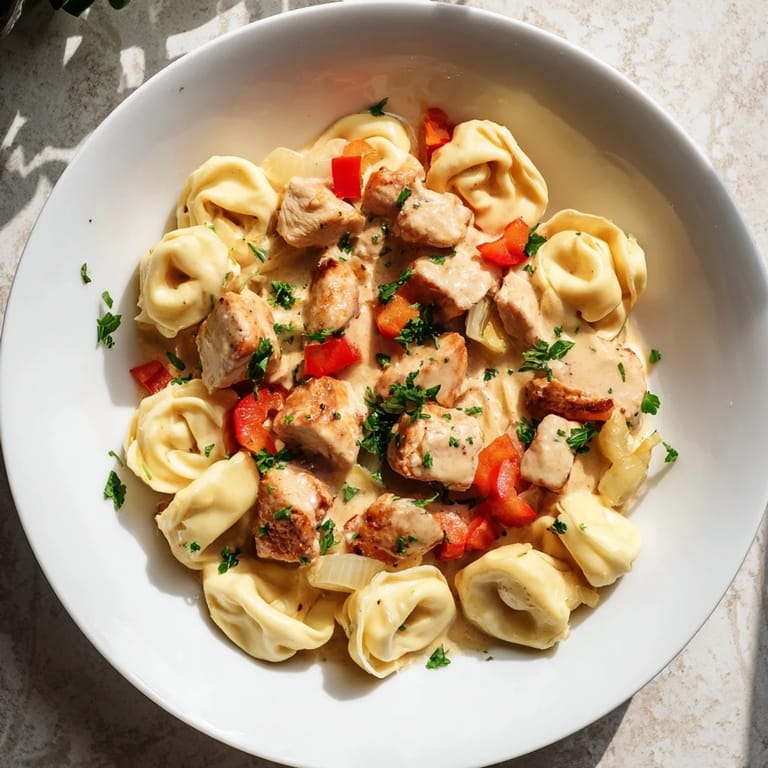 Tender chicken and cheesy tortellini bathed in a spicy Cajun garlic Parmesan sauce dish.