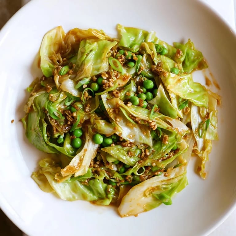 A flavorful Cabbage Stir-Fry featuring vibrant green peas and savory garlic, perfect vegetarian side dish.