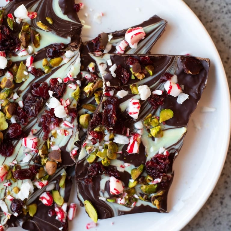 A close-up of beautifully marbled Holiday Bark, filled with textures like toasted coconut and crushed candies.