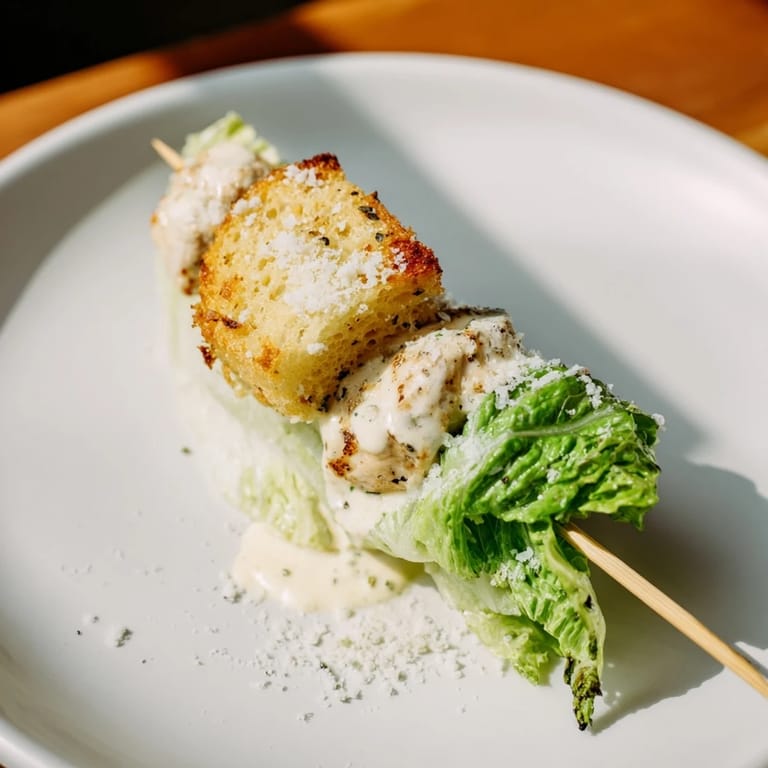 These flavorful Chicken Caesar Salad Skewers are a quick appetizer, drizzled with creamy Caesar dressing.