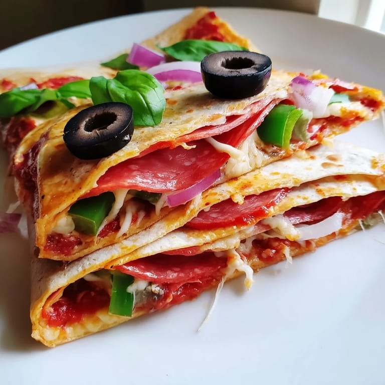 Crispy tortilla pizza wrap, featuring folded layers loaded with cheese and delicious fresh toppings.