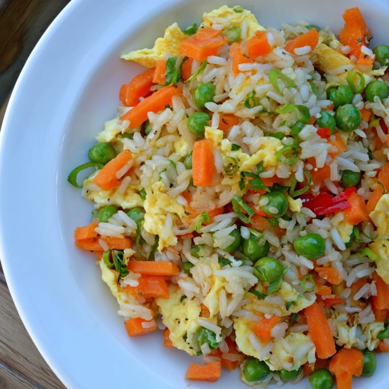 Enjoy freshly made Egg Fried Rice, a vegetarian-friendly stir-fry seasoned with soy sauce.