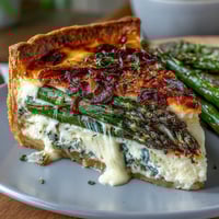 Spring Asparagus Quiche with Gruyère and caramelized shallots in a flaky golden crust, perfect for brunch or lunch.